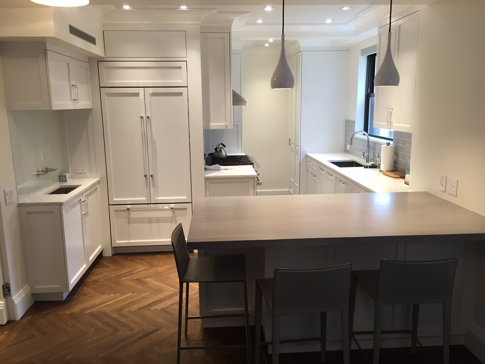 Modern kitchen with white cabinets and island seating