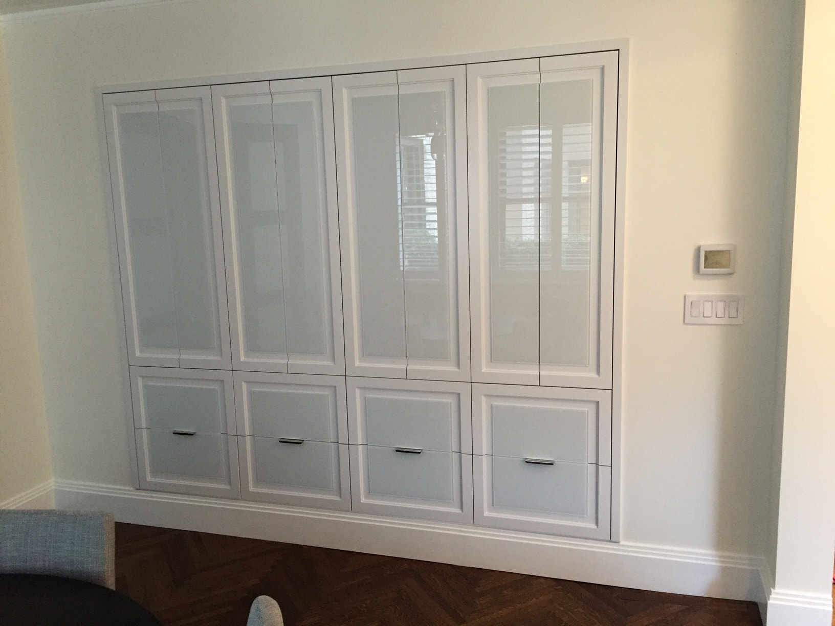 White built-in cabinet with glass doors